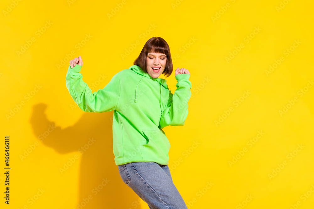 Canvas Prints Portrait of attractive cheerful dreamy girl dancing enjoying clubbing relax isolated over bright yellow color background