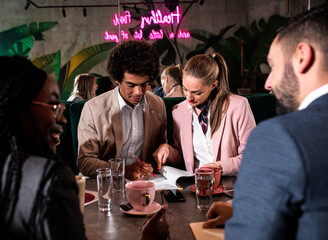 Group of business people having meeting in cafe.