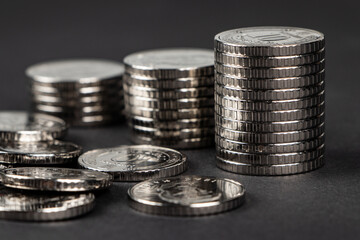 Ukrainian 10 hryvnias coins. Money and finances. Stack of 10 hryvnia coins, on a dark background....