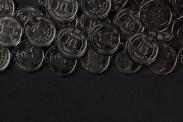 Silver coins on dark background. Ukrainian 10 hryvnias coins. Money and finances. Ukrainian coins.