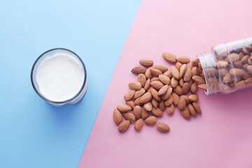 top view of almond nut and milk on color background 