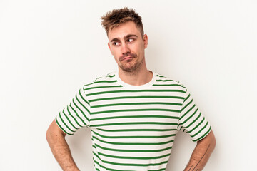 Obraz premium Young caucasian man isolated on white background confused, feels doubtful and unsure.