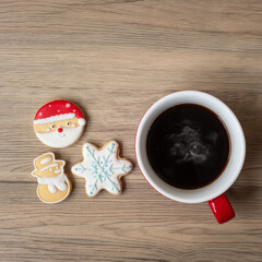 Merry Christmas with homemade cookies and coffee cup on wood table background. Xmas eve, party, holiday and happy New Year concept