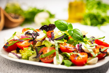 salad with tomato and basil leaves