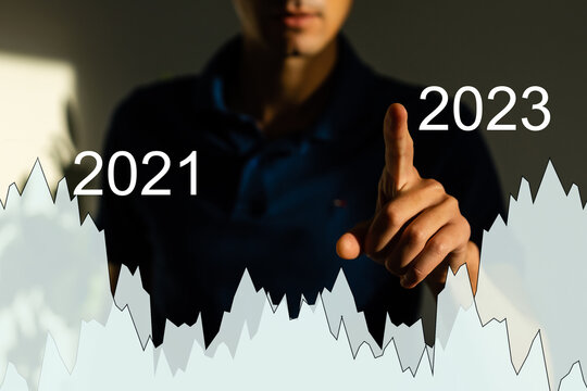Finger pressing blue start 2023 button on virtual interface on gray background with copy space for text. Concept of new year. Businessman pressing 2023 start up business. Beginning of New Year 2023