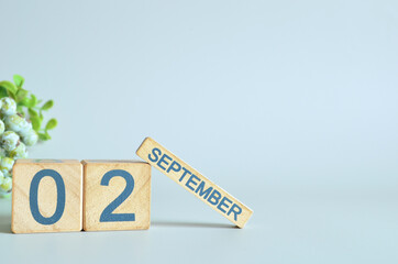 August 2, Calendar cover design with number cube with green fruit on blue background.