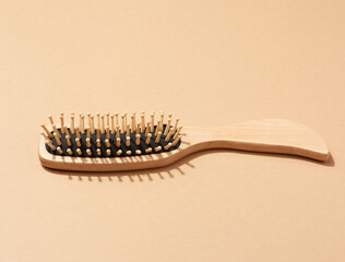 wooden hair comb on brown background, zero waste.