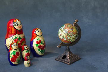matroshka, dolls forming a family looking at the globe