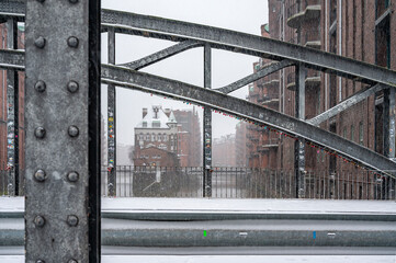 The Speicherstadt in Hamburg on a cold winter day with snow flakes in the air