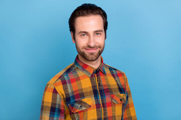 Photo of sweet shiny young guy dressed checkered shirt smiling isolated blue color background