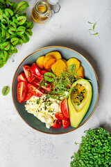 Scrambled eggs with cherry tomatoes , avocado, fried potatoes