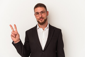 Young business caucasian man isolated on white background joyful and carefree showing a peace symbol with fingers.