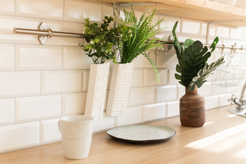 Home interior of a trendy, stylish, bright Scandinavian-style kitchen with open shelves. Loft interior