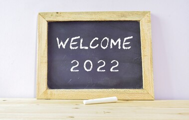 Fototapeta premium Chalkboard with the text Welcome 2022. Holidays, new year celebration concept.