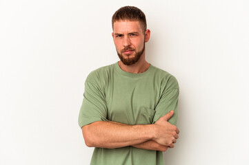 Young caucasian man with diastema isolated on white background frowning face in displeasure, keeps...