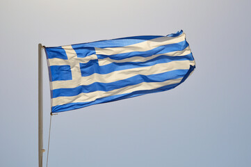 Obraz premium Sunlit Greek flag waving in the wind