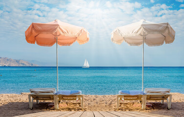 Sandy beach with resting sunshades and deck chairs  shore of the Red Sea, Middle East 