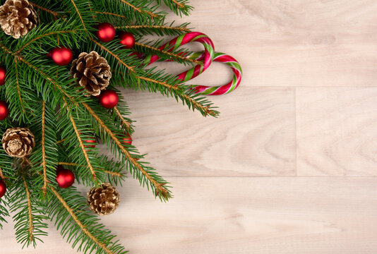 Christmas spruce branches with decorations on a wooden background top view frame stock images. Christmas decorations and spruce twigs on a wooden background with copy space for text stock photo