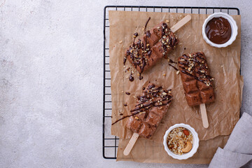 Chocolate ice cream popsicle with nut