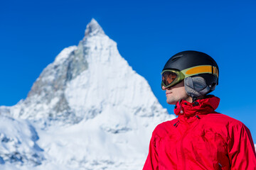Skier enjoying the Alpine view. Snow mountain range with Matterhorn on the background. Zermatt Alps region Switzerland.