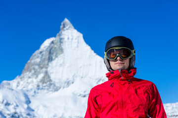 Skier enjoying the Alpine view. Snow mountain range with Matterhorn on the background. Zermatt Alps region Switzerland.