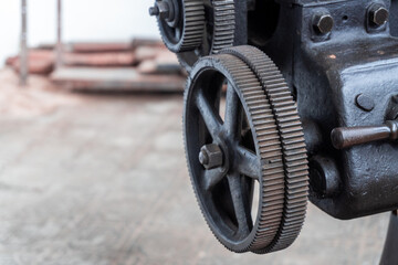 Detail of the gears and cogwheels of an old industrial machine. 