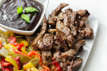 Beef strips with mixed peppers and mangetout served with black bean sauce