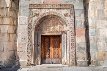 entrance portal to the church and monastery of Geghard in Armenia with ornamental carvings