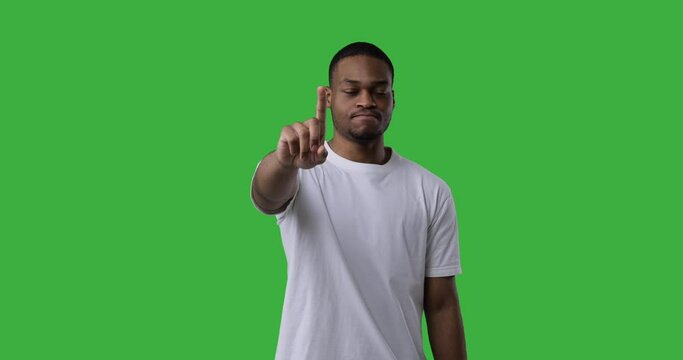 African American Man Saying No By Waving His Finger Over Green Background