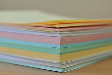 stack of multi-colored stickers close-up. pastel paper