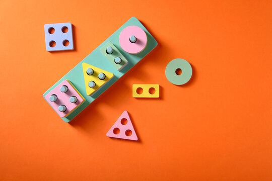 Educational toys for children in the form of different geometric shapes on an orange background