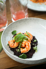 Black risotto with roasted shrimps	