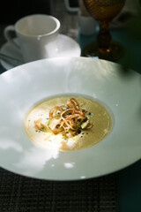 Cheese soup with fried onion and shrimps