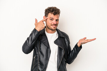 Young caucasian man isolated on white background showing a disappointment gesture with forefinger.