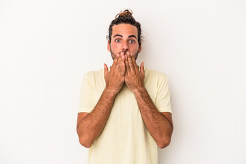 Young caucasian man isolated on white background shocked, covering mouth with hands, anxious to discover something new.
