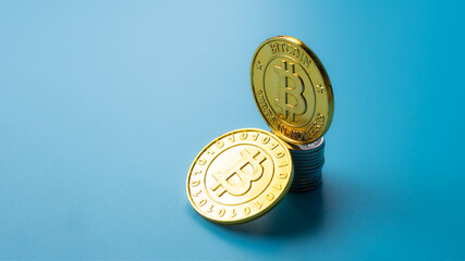 Golden bitcoin coin on cyan background . Bitcoin Gold blockchain hard fork concept..
