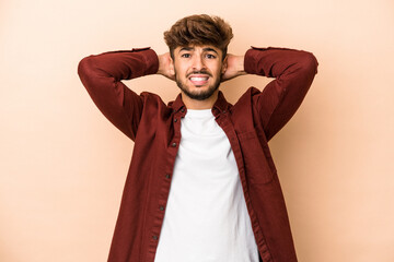 Young arab man isolated on beige background screaming with rage.