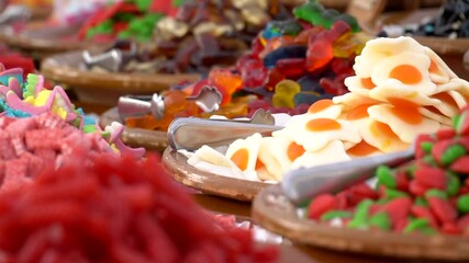 Red strawberries shaped sweet candies for sale on the market. Delicious multi colored candies. Delicious fruit shaped candies. Unhealthy candies in bulk.