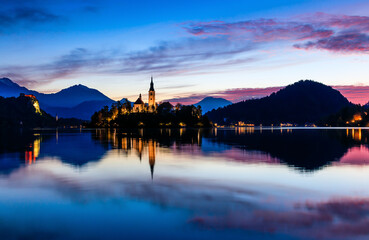 Lake Bled, Slovenia. Sunrise at Lake Bled with famous Bled Island and historic Bled Castle in the...