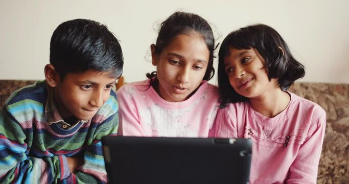 A 4K of South Asian siblings looking at the tablet screen. Shimla, Himachal Pradesh, India