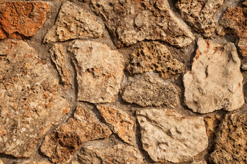 Modern seamless wall made of natural red and white stone, background and texture of old brick walls.