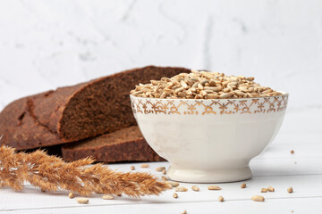 Sliced ​​rye bread on a cutting board. Whole grain rye bread with seeds
