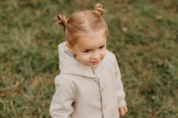 Autumnal mood. Portrait of a little cute girl walking in the autumn park