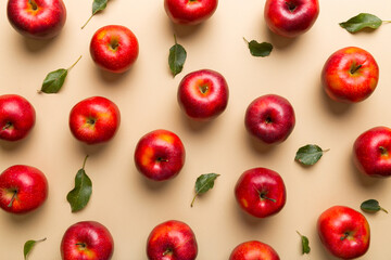 Many red apples on colored background, top view. Autumn pattern with fresh apple above view