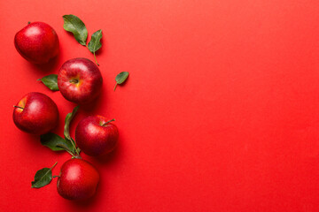 Many red apples on colored background, top view. Autumn pattern with fresh apple above view with copy space for design or text