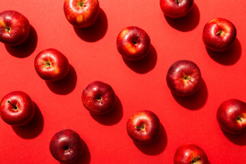Many red apples on colored background, top view. Autumn pattern with fresh apple above view