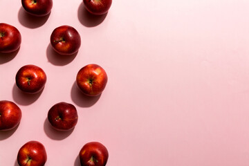Many red apples on colored background, top view. Autumn pattern with fresh apple above view