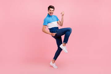 Fototapeta na wymiar Full body photo of funny brunet millennial guy stand wear polo jeans sneakers isolated on pink background