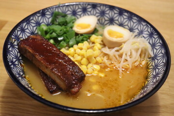 Ramen cooked in pork broth with minced mushrooms, pasta, chopped rings, green onions, corn and boiled egg