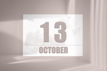october 13. 13th day of the month, calendar date.White sheet of paper with numbers on minimalistic pink background with window shadows.Autumn month, day of the year concept